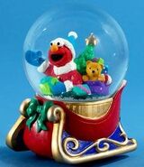 Musical snowglobe with Elmo on a sled. Plays "Let it Snow, Let it Snow, Let it Snow!" (2007)