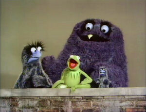The Sesame Street version of Splurge with , , and a small monster.