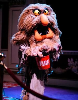 Sweetums rushes in with a fire bucket.