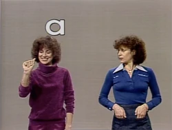 Two Lindas sign the alphabet