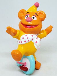Baby Fozzie as a clown on a unicycle