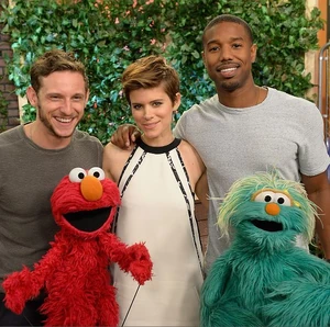 Jamie Bell, left, with  and , and furry friends Elmo and Rosita