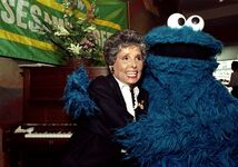 Horne with Cookie Monster during a gathering marking the broadcast of Sing! Sesame Street Remembers Joe Raposo and His Music