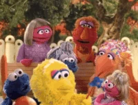 Baby Big Bird blows on a pinwheel in Sesame Beginnings: Moving Together