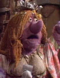 Ma Gorg, as seen in the first episodes of Fraggle Rock. Her long bangs were initially radio-controlled so that they could move sideways to cover or expose her eyes. This effect was later replaced with blinking eyelids.