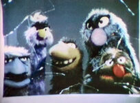 The Flute-Snatcher and his gang of monsters break a man's window in a Number Song Series segment on Sesame Street.