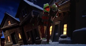 Bob Cratchit and Tiny Tim walk down the street singing