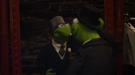 In Muppets Most Wanted, Kermit hides from Constantine in the Tower of London by matching his movements in a mirror frame.
