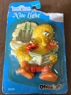 Big Bird reading a fairy tale book to Elmo and Zoe