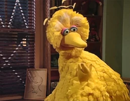 Big Bird props the picture on the windowsill next to his nest of pillows when he is forced to stay with Maria and Luis after the hurricane in 2001.