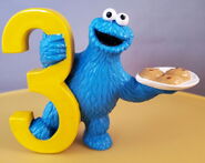 Cookie Monster with 3 cookies on a plate