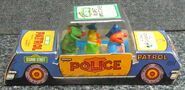 Sherlock Hemlock, Bert, and Ernie in a police car