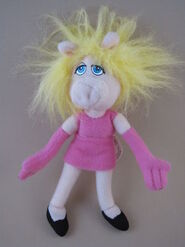 Miss Piggy in a pink mini-dress and gloves