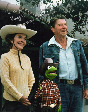 Kermit in an altered picture with Ronald and Nancy Reagan as seen in The Muppets.