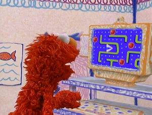 Elmo playing his Pac-Man clone.