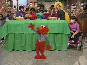 Elmo struts his stuff at a dance party.