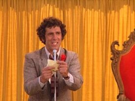 Elliott Gould announces the winner of the Bogen County beauty contest.