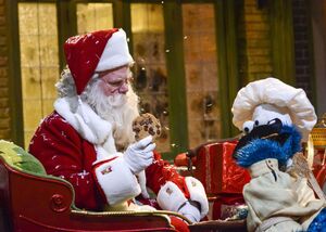 Cookie Monster's ancestor shares a cookie with Santa Claus in Once Upon a Sesame Street Christmas.