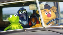 Fozzie Bear driving a Ford Super De Luxe in The Muppet Movie