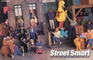 Kermit with Sesame Street Muppets and performers in a two-page spread from a 1999 issue of People.