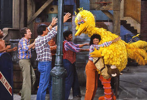 Big Bird, with his loving Sesame Street family.