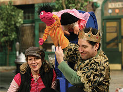 Paul Rudd gives puppetry a try with Roosevelt Franklin, watching the monitor with Leslie Carrara-Rudolph.