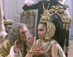 The Sorceror pleads with Cleopatra, played by an uncredited extra, in Gulliver's Travels