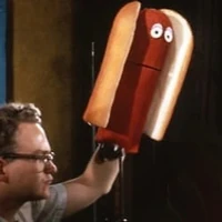 A Muppet hot dog (performed by Jerry Juhl) in the Wilson's Meats commercial "Make Me a Hot Dog"
