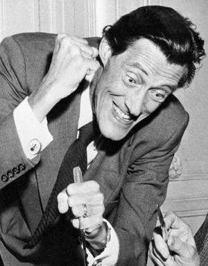 John Carradine devouring scenery, and a co-star, in a 1956 publicity shot