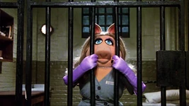 Miss Piggy is arrested and held in one of Her Majesty's prisons after being framed for stealing Lady Holiday's necklace in The Great Muppet Caper.