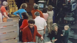 The cast and crew watch a playback of scene 3.