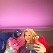 Kelly takes a selfie with the Muppets while on set filming a segment for Sesame Street Season 47