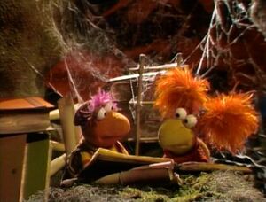 Gobo and Red consult the Fraggle's "Encyclopedia Fragglia"