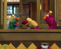 Two Honkers use oven mitts as puppets in the Sesame Street in Communities video "The World Sings to You."