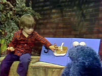 1220-Shoe.jpg (125 KB) Cookie Monster talks to a boy about the letter S (First: Episode 1158)
