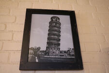 Rizzo at the Leaning Tower of Pisa in a framed photograph at PizzeRizzo