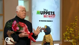 Dennis Basso has flowers for Miss Piggy
