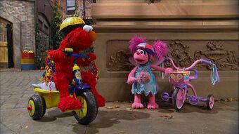 elmo riding a bike