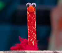 Elmo performs a popsicle stick puppet named Sticky in Episode 5116 of Sesame Street.