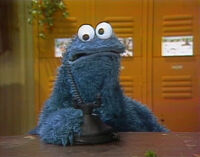 Cookie Monster has a hard time calling Santa Claus.