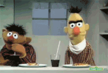 Ernie drinks grape juice in a Sesame Street sketch