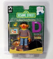 Ernie figure, with Rubber Duckie, a picture of Ernie and Bert, a brick wall, a banana, and the letter D