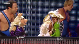 Kelly Kelly lays one on Kermit.