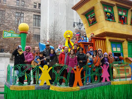 A group photo of the Sesame Street cast on the float, 2010