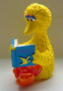 Big Bird reading a book on Birds