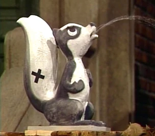 "famous Grouch statue of a skunk in deep concentration...The Stinker" from Sesame Street Episode 2870 (1991)
