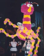 Behind the scenes, dancers prepare one of the bugs for "The Night Bug Boogie."