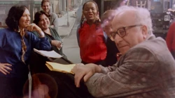 The cast gather around to practice their "Trash Can Life" song.