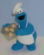 Cookie Monster with a tray of cookies