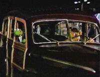 Fozzie Bear driving a Ford Super De Luxe in The Muppets Go Hollywood